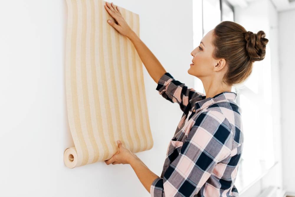 Someone testing a striped, yellow wallpaper in a home near Newport News, Virginia (VA)